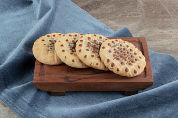 Homemade cookies stuffed with chocolate on wooden board