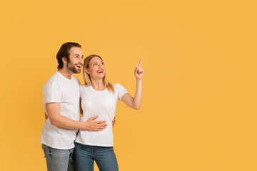 Glad inspired handsome young caucasian female and man in white t-shirts hugs, show thumb up