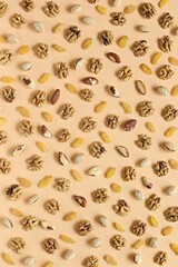 Nuts and dried fruits assortment on light pastel background. Natural energy source rich in vitamins and minerals. Flat layot