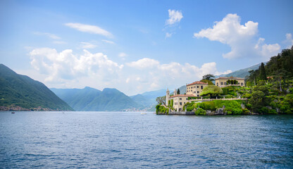 Panoramic of lake Como with Villa Monastero surrounded by water and mountains on a sunny day. Fancy...