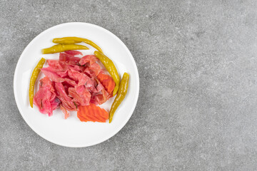 Assortment of homemade pickles on white plate