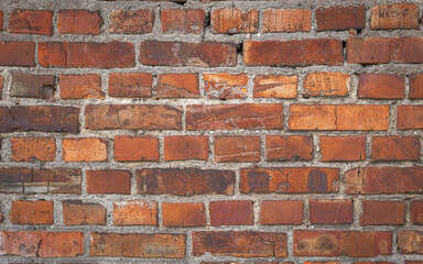 Old red brick wall grunge texture. Old cracked bricks wall with a weathered surface