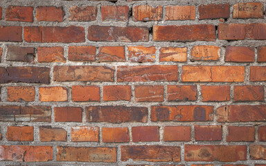Fototapeta premium Old red brick wall grunge texture. Old cracked bricks wall with a weathered surface