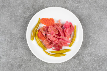 Assortment of homemade pickles on white plate