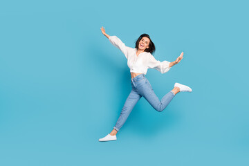 Fototapeta na wymiar Full length photo of cheerful lovely person toothy smile jumping isolated on blue color background