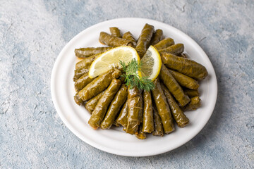 Delicious dolma (sarma) stuffed grape leaves rice. Lebanese dolma sarma on plate. Lebanon turkish greek middle eastern cuisine. (Turkish name; Yaprak sarma)
