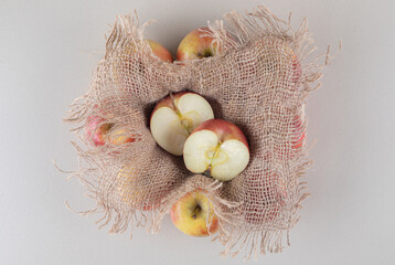 Apple bundles and a piece of cloth on marble background