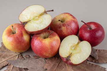 Apple pile and plane tree leaves on marble background