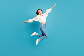 Full body photo of overjoyed pretty lady jumping flying good mood isolated on blue color background