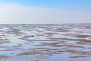 Seascape beach mudflats hiking on the North Sea coast Germany.