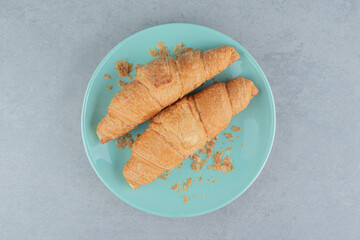 A display of croissant on plate on the marble background