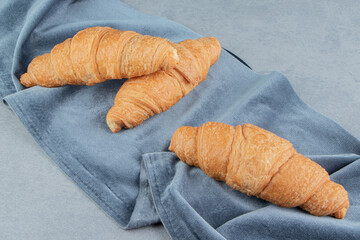Delectable croissant on towel , on the marble background