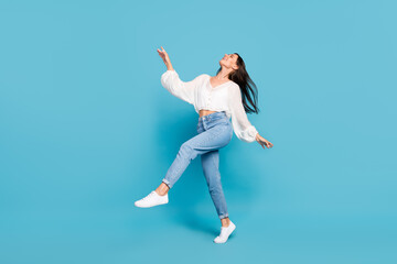 Obraz premium Full body portrait of adorable cheerful lady enjoy chilling dance isolated on blue color background