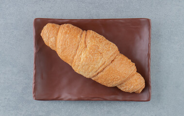 Delicious croissant on plate , on the marble background