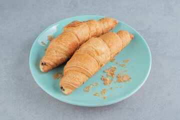 A display of croissant on plate on the marble background