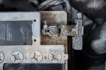 Old starter battery in a car