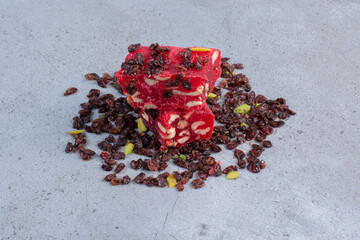 A small stack of Turkish delights and raisins on marble background