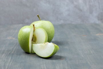 Sliced green apple isolated on a wooden table