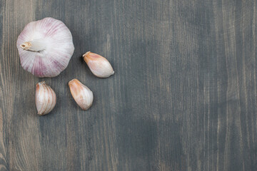 Raw garlic with segments isolated on a wooden table