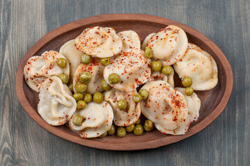 Delicious dumplings with peas and red pepper