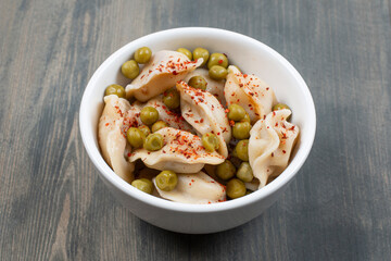 Delicious dumplings with peas and red pepper