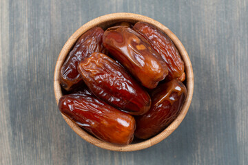 Dried tasty dates in a wooden bowl