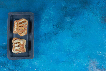 Toothsome cookies on the board, on the blue background