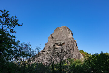 Cave in the rock of the Holy Spirit near Roussanou Monastery, formerly used to confine wayward monks. Kalambaka, Meteora, Thessaly district, Greece, Europe. Monk Prison. Clear blue sky on summer day