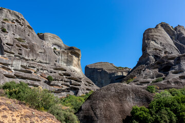 Cave in the rock of the Holy Spirit near Roussanou Monastery, formerly used to confine wayward monks. Kalambaka, Meteora, Thessaly district, Greece, Europe. Monk Prison. Clear blue sky on summer day