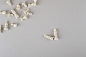 White chess pieces scattered on marble background