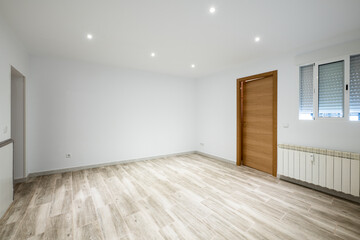 Empty living room with white aluminum windows with sliding leaves and gray stoneware floor and access to a room