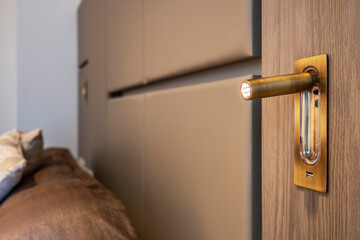 Obraz premium Design lamp in brass with usb connection in the headboard of a bedroom