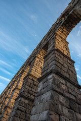 Fototapeta na wymiar Contrapicado image of stone arches of the Roman aqueduct of Segovia