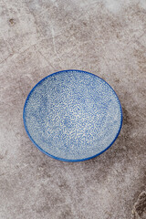 empty blue dotted bowl on a gray background