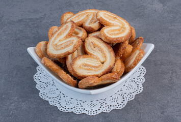 Pile of delicious biscuits in white bowl