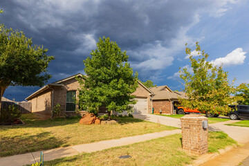 Sunny view of a community with storm clouds overhead