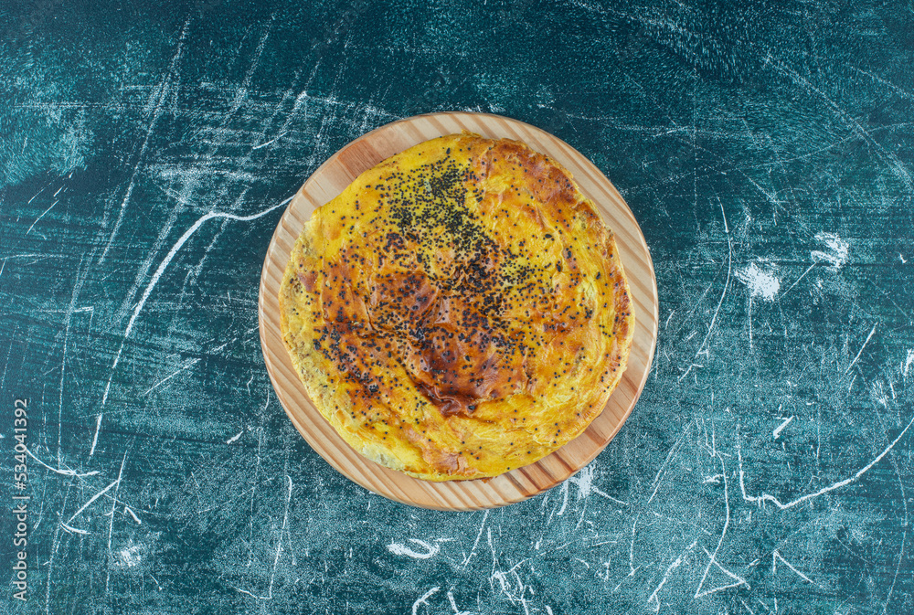 Wall mural Delicious pastry with poppy seeds on a wooden plate