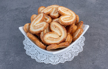 Pile of delicious biscuits in white bowl