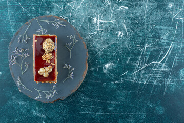 A piece of delicious cake with walnut on a plate
