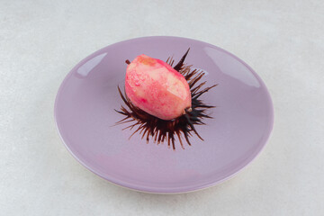 Fresh red nectarine on purple plate