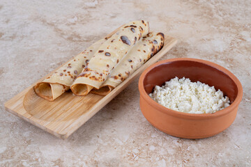 Homemade pancakes with cottage cheese on a wooden board