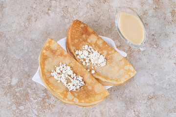 Roll sweet delicious pancakes with cottage cheese