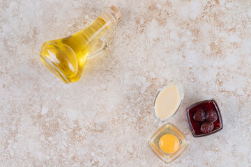 A glass bottle of oil with jam and raw egg