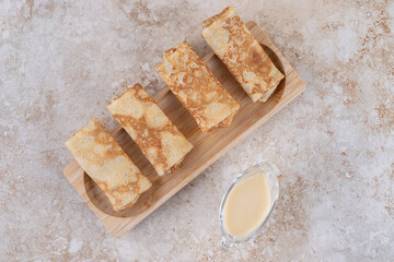 A wooden board of tasty homemade crepes