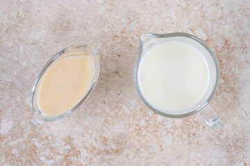 A glass cup of cold delicious milk on a marble background