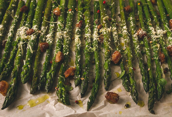 grilled asparagus, with spices and herbs, parmesan cheese, on a white background, top view, rustic, no people