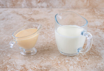 A glass cup of cold delicious milk on a marble background