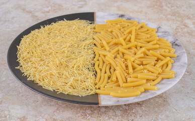 Two types of uncooked macaroni on a beautiful plate