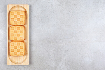 A wooden board of sweet delicious cookies
