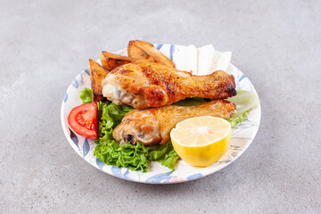 Delicious fried chicken legs meat with spices and vegetables